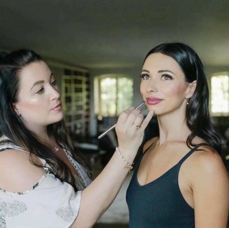 Christina applying makeup to a client